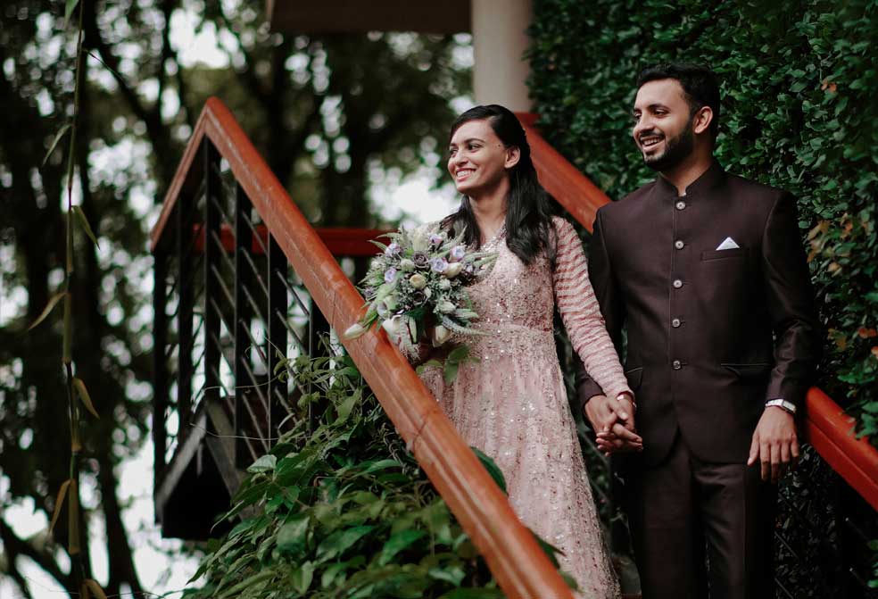 couple on the stairway for wedding at the cardamom county by xandari resorts